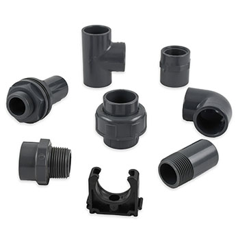 Selection of PVC fittings including elbows, tees, sockets, and reducers for industrial pipe systems.